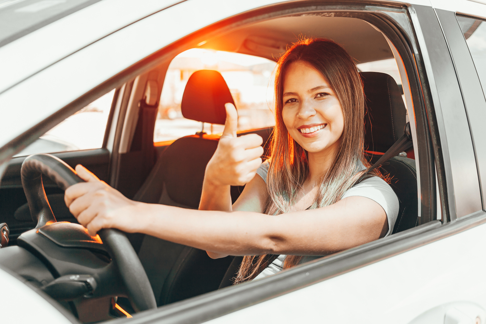 Mujer joven con cobertura de seguro para carro