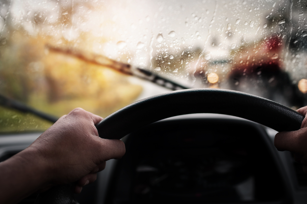 sideview of car driving in the rain