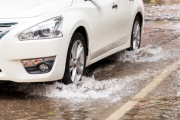 driver in car moving through the rain on wet road