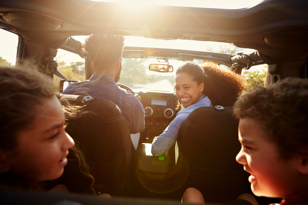 happy family in car with texas auto insurance