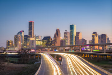 houston skyline at dusk with cars with texas insurance