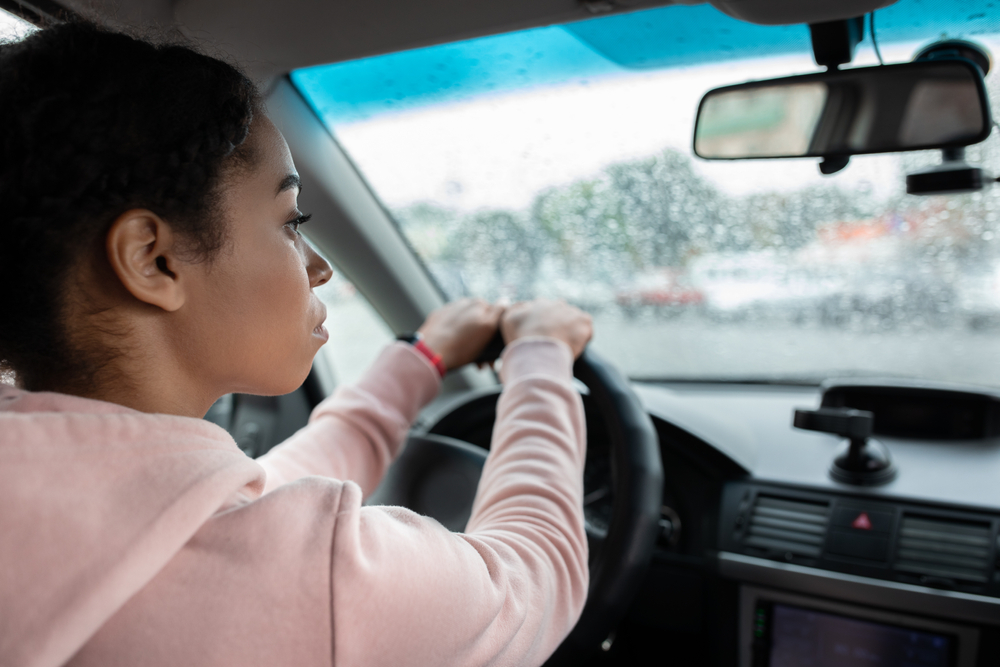 woman driving car in the rain