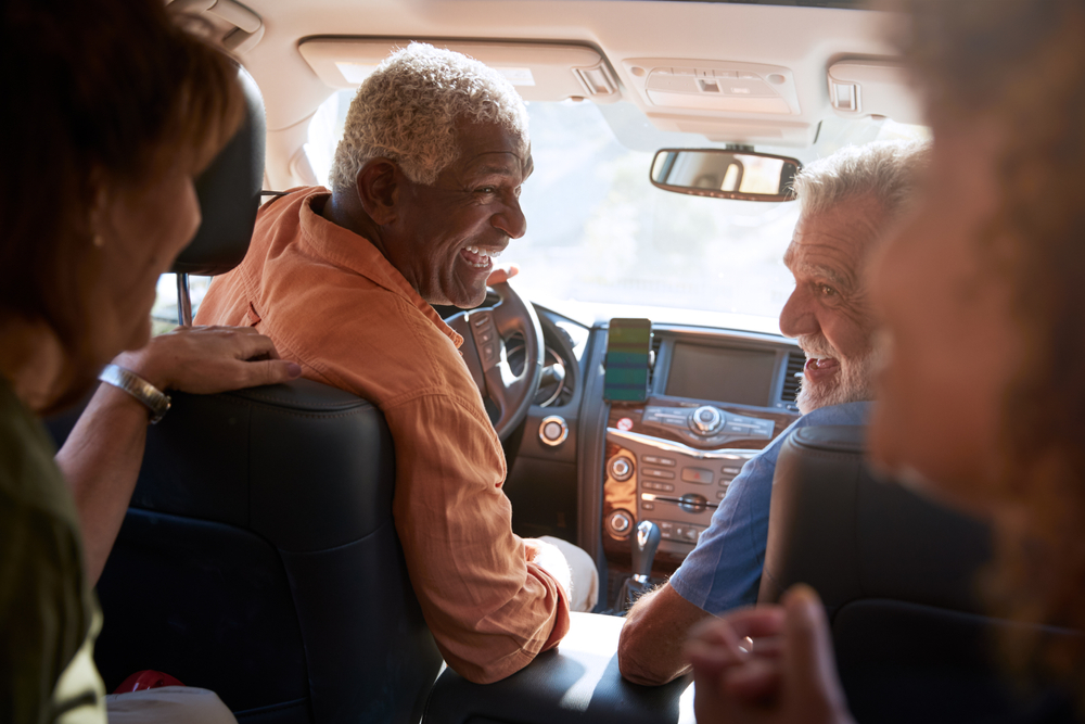 Group Of Senior Friends Enjoying Road Trip In Car Together