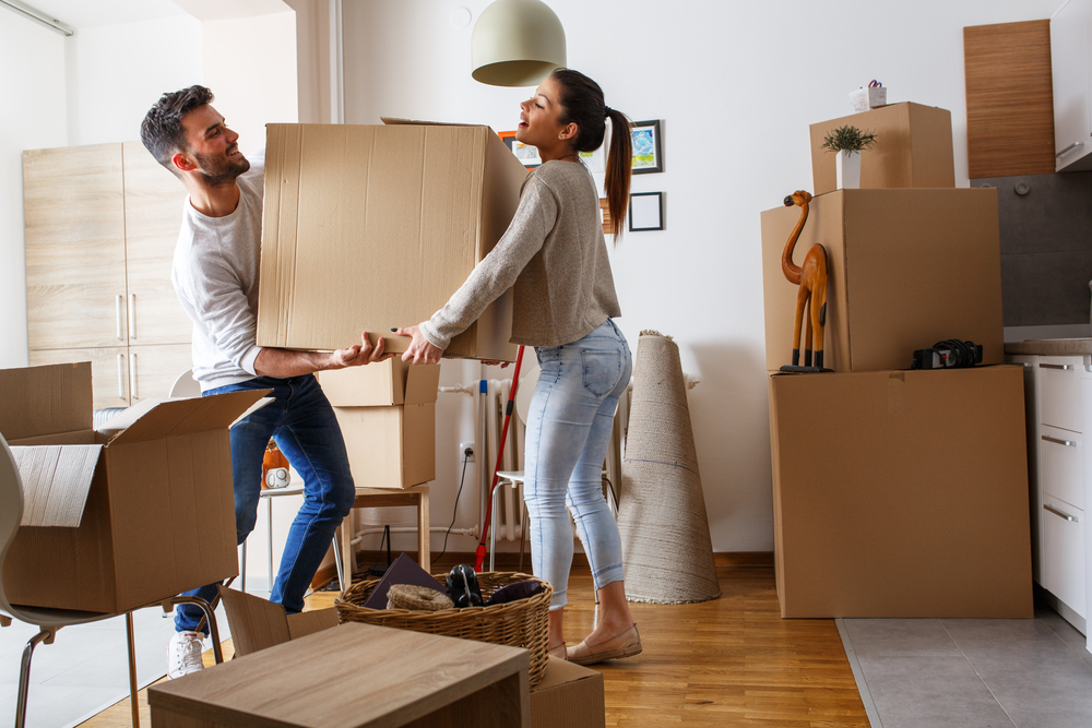 couple moving into apartment with boxes
