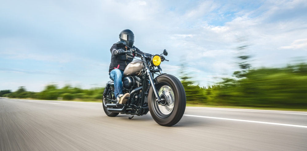 man riding motorcycle on road