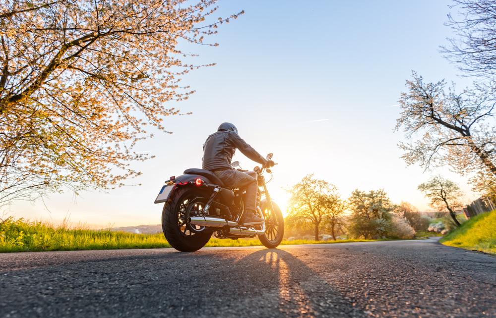 motorcycle driving on road in spring