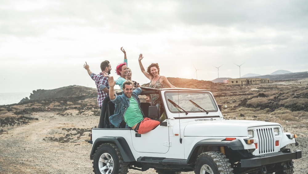 Young people having fun in a jeep