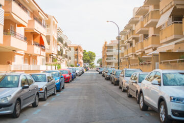 cars lined up outside apartment complex