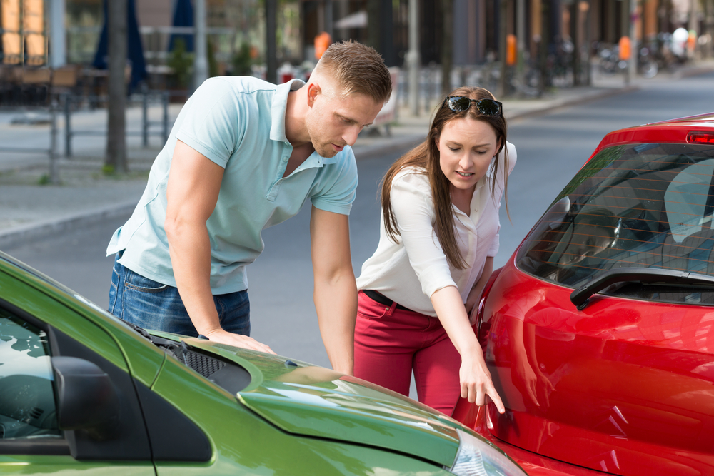 man and woman showing at-fault car accident