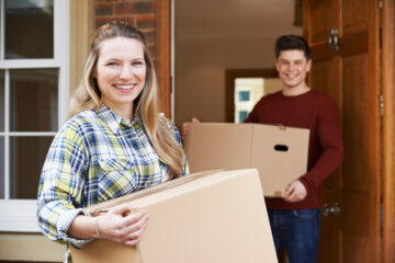 couple with boxes moving into new rental home