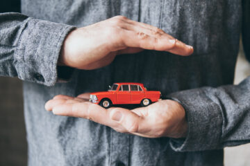 man holding toy car between hands
