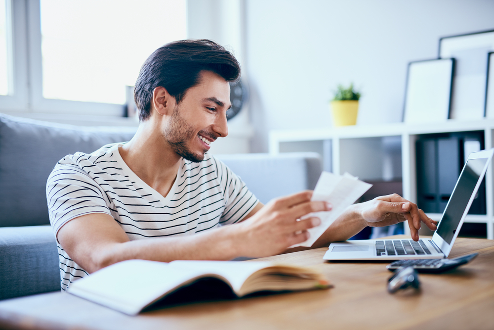 man paying bills at computer