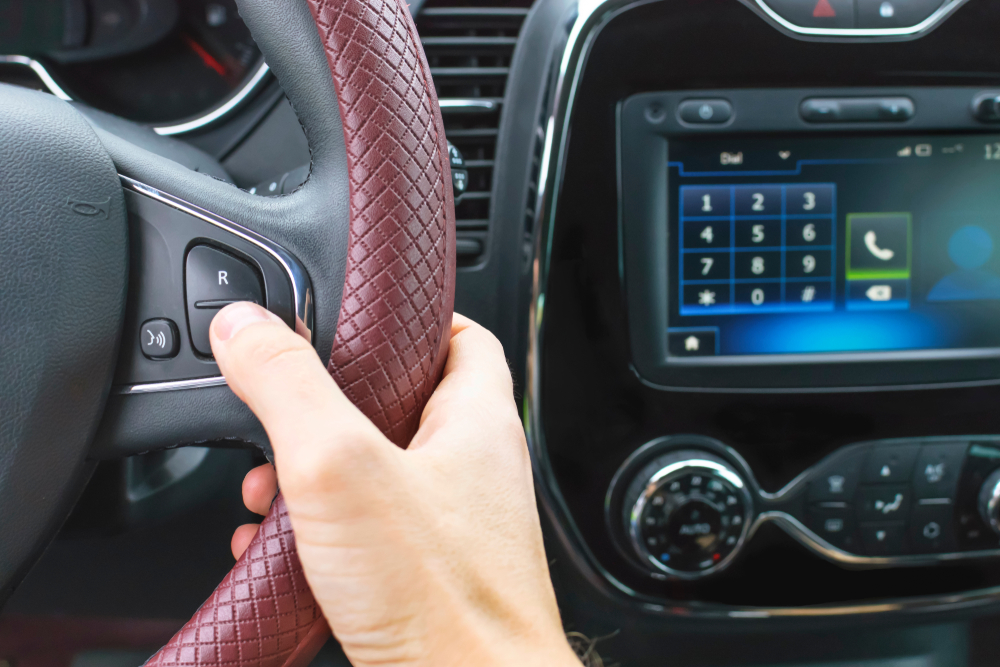 person using hands free talk in car