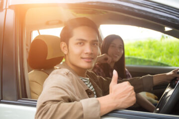 Two young people driving in a car